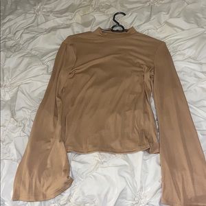 Nude turtleneck with bell sleeves